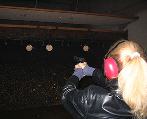 Heather Bosch shoots a semi-automatic weapon during NRA training class for her news series Taking Up Arms