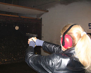 Heather Bosch fires a weapon for the first time in a NRA training class for her news series Taking Up Arms