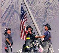 Members of the FDNY raise an american flag at Ground Zero, 2001