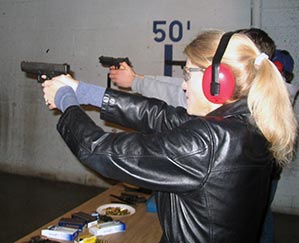 Heather Bosch practice firing a hand gun during NRA certification training for her series Taking Up Arms