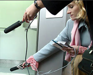 Heather Bosch covering the first flush of the first self-cleaning toilets for downtown Seattle while reporting for KIRO Radio.