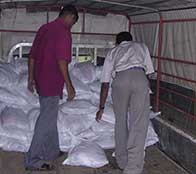 Aid workers stack bags of supplies for tsunami victims as Heather Bosch reports from Sri Lanka