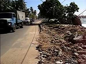 A road on the coast of Galle with a damaged boat on the right side -- after a tsunami hits Sri Lanka in 2004.