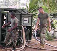 S Marines help tsunami victims recover by setting up a water cleaning machine